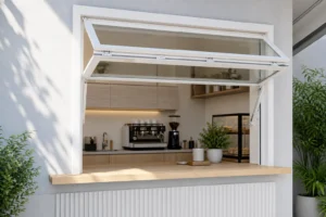 White RGNL-60 style manual vertical folding window installed above a cafe service counter