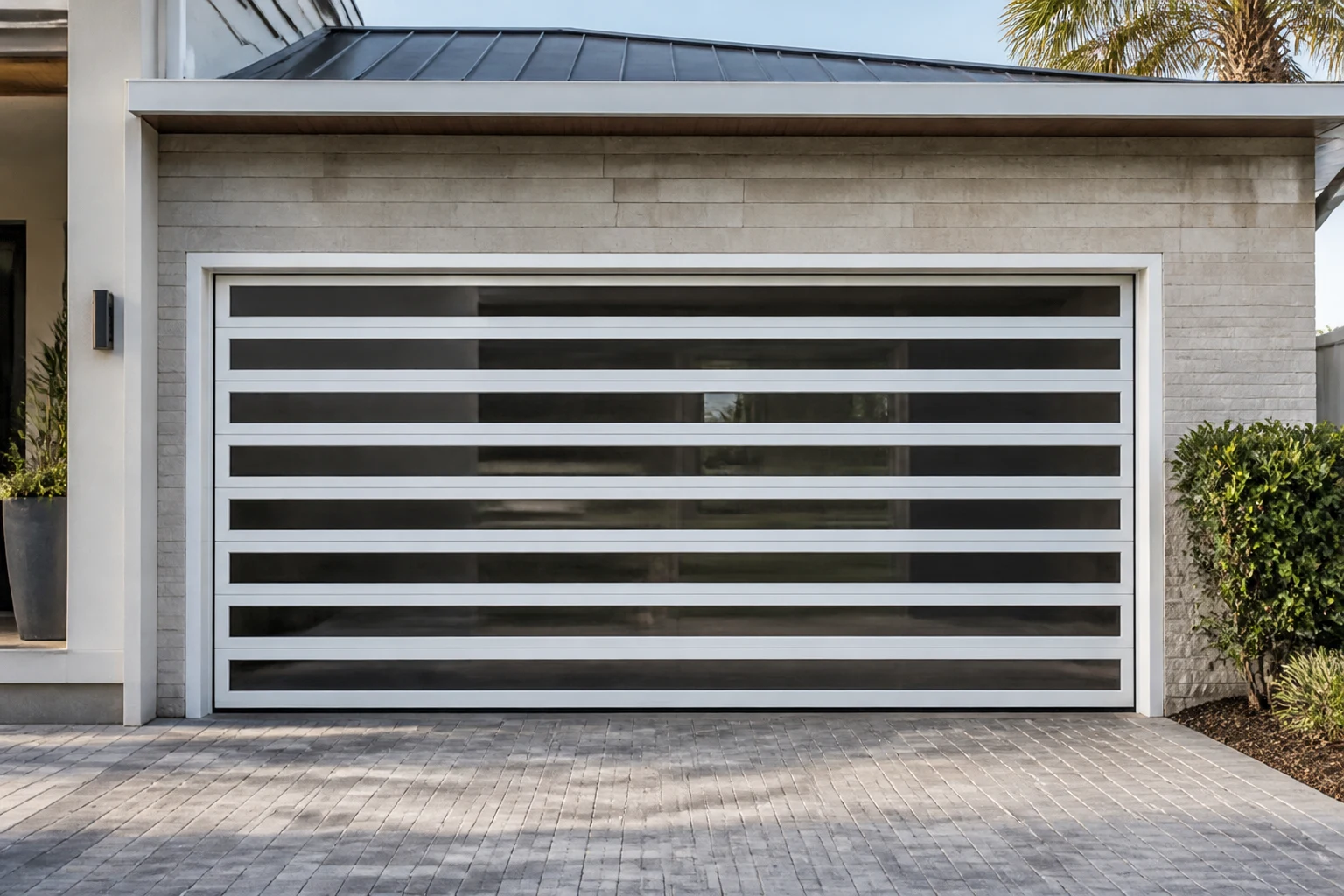 RGNL White Grille Garage Door Villa Scene White RGNL grille garage door with horizontal aluminum bars and glass panels installed on a modern villa