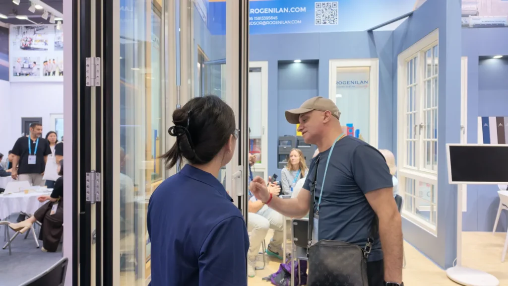 Door panels and a product conversation at the Rogenilan booth in April 2026