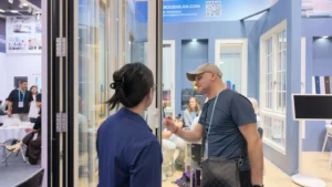 Door panels and a product conversation at the Rogenilan booth in April 2026
